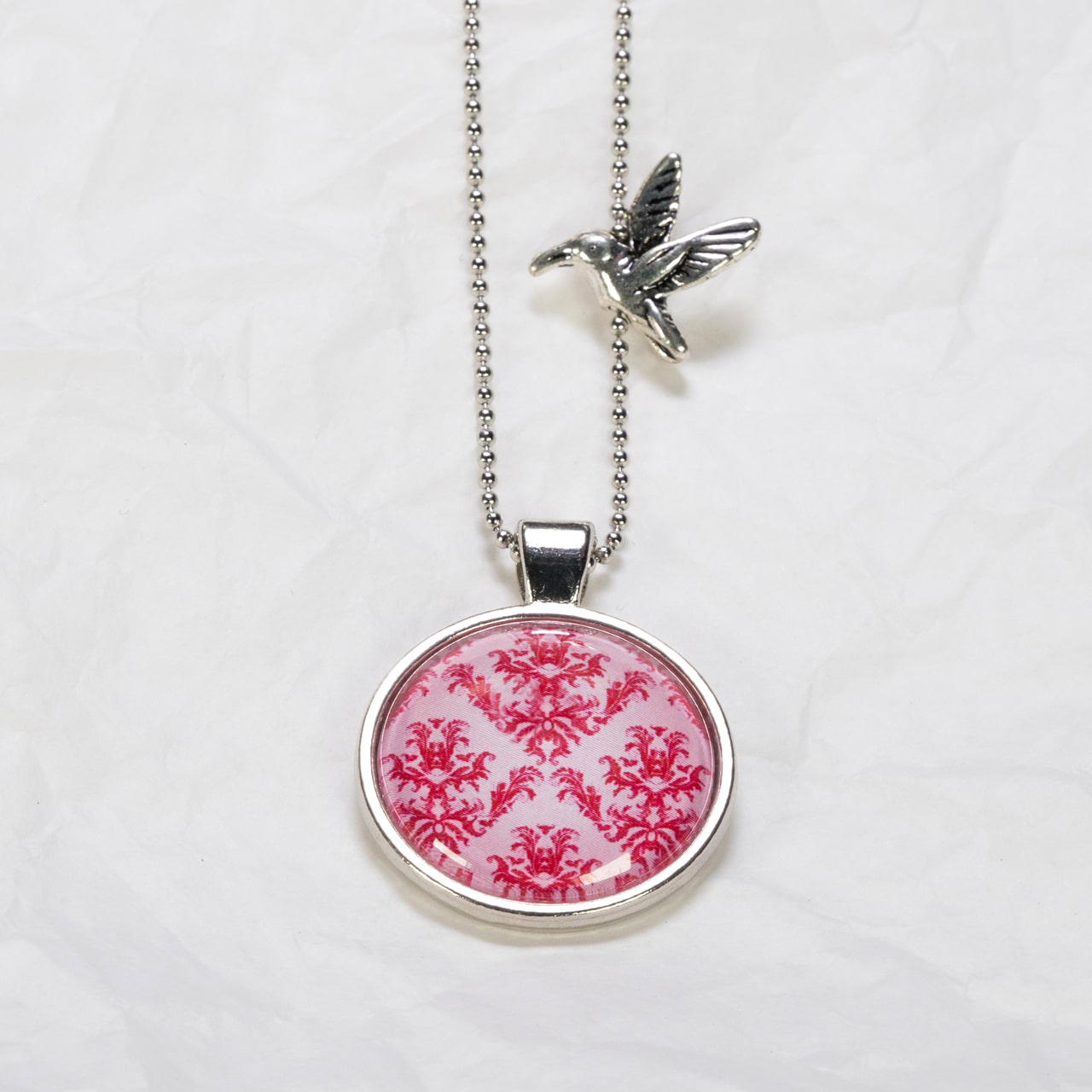 Medaillon-Halskette Magenta Blumen auf Pink